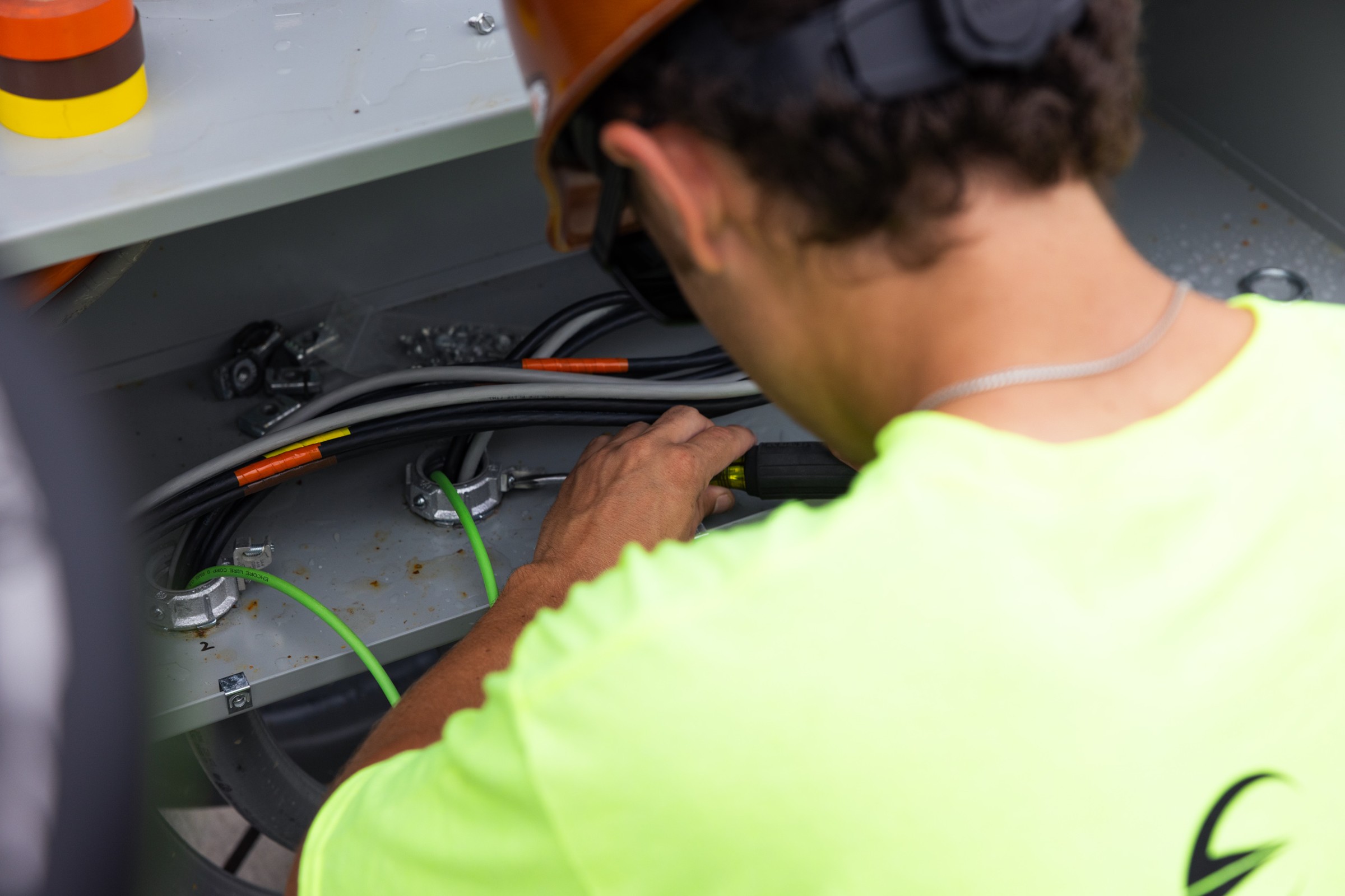 Electrician working on electrical equipment