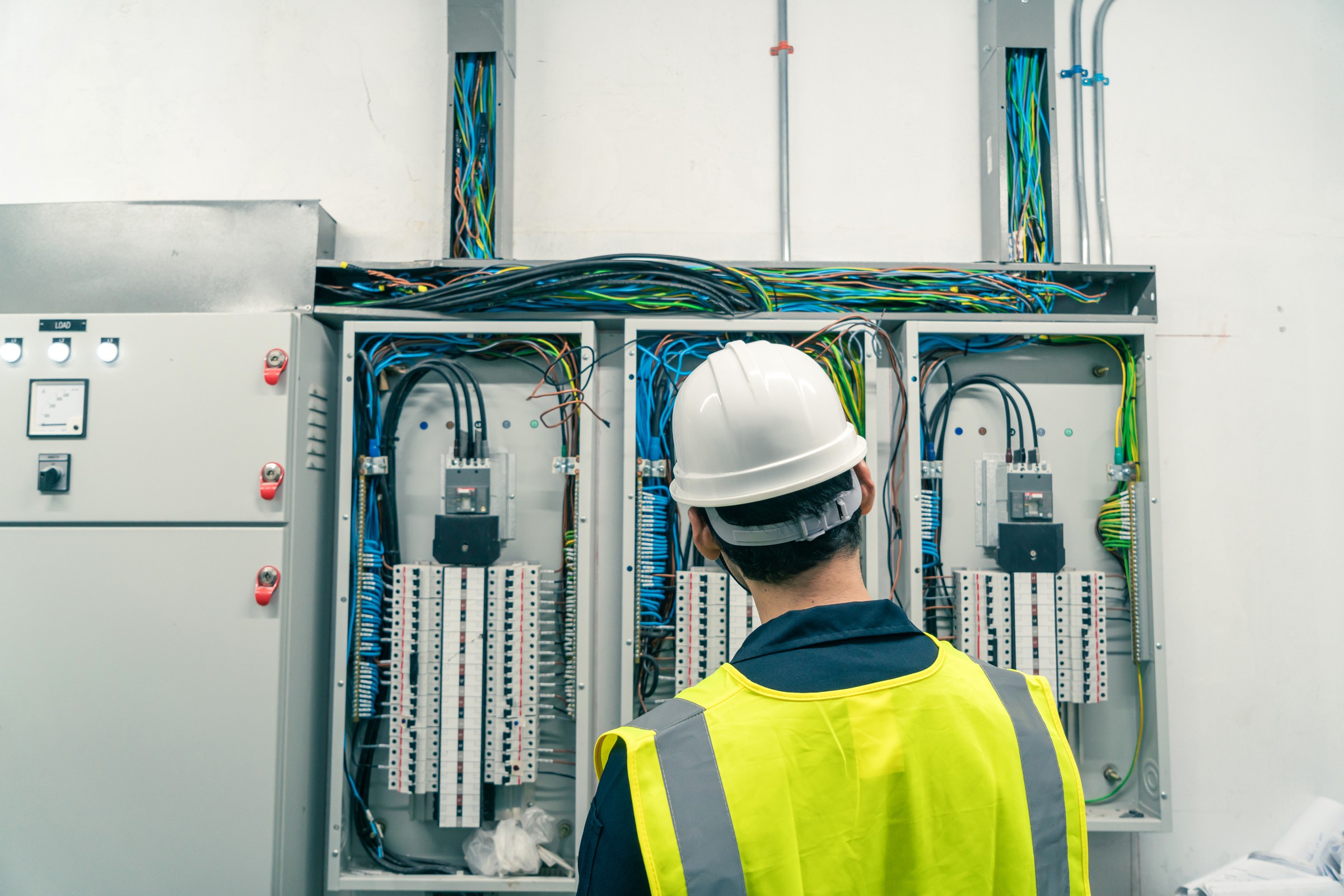 Electrician working at electrical switchgear