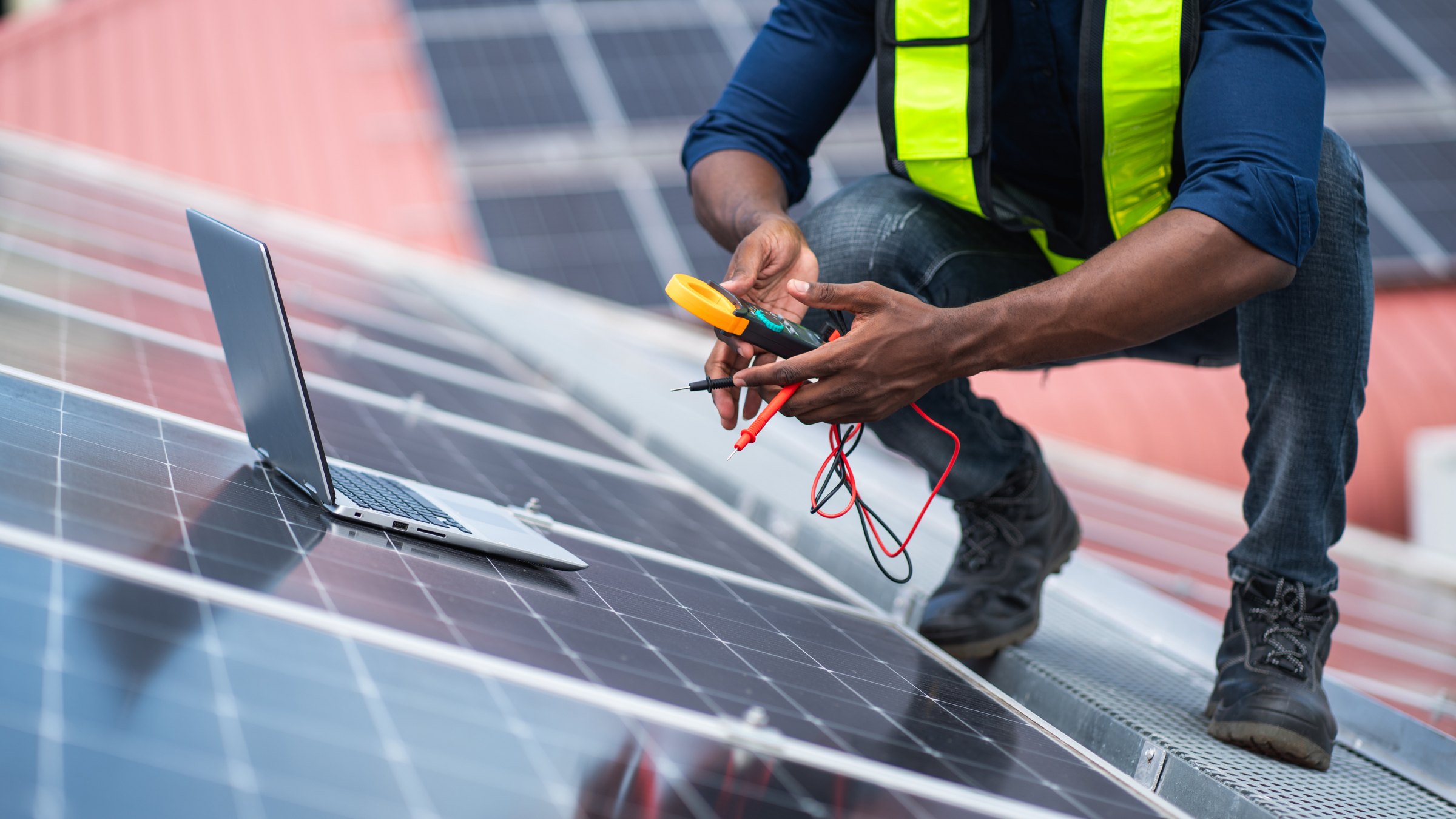 Technician testing a solar panel